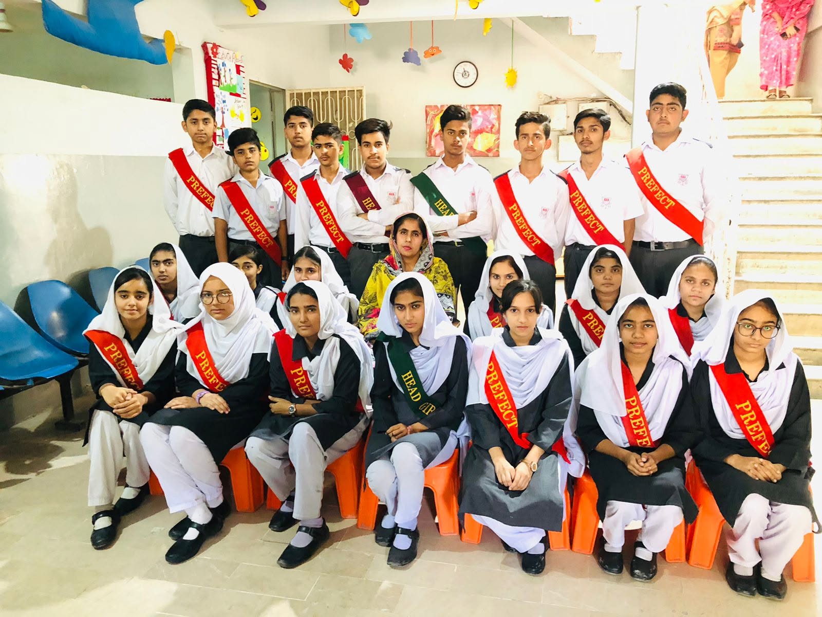 Pakistani HGS students in white and grey school uniform